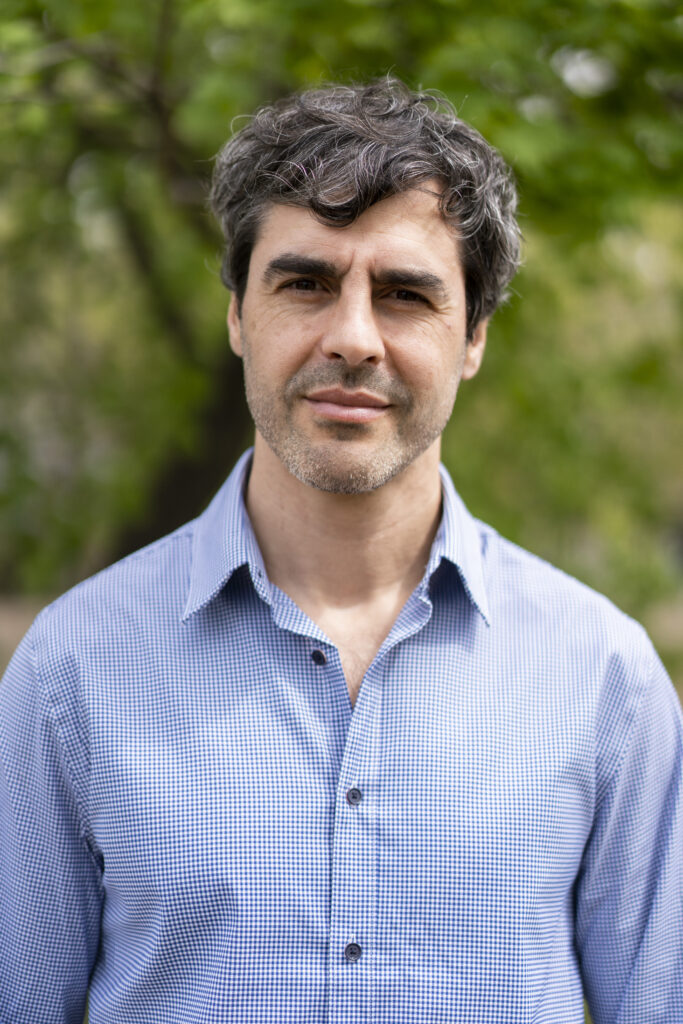 A picture of Juan Ferre in a blue button down shirt, looking into the camera. 